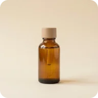 Amber skincare serum bottle on a warm cream background